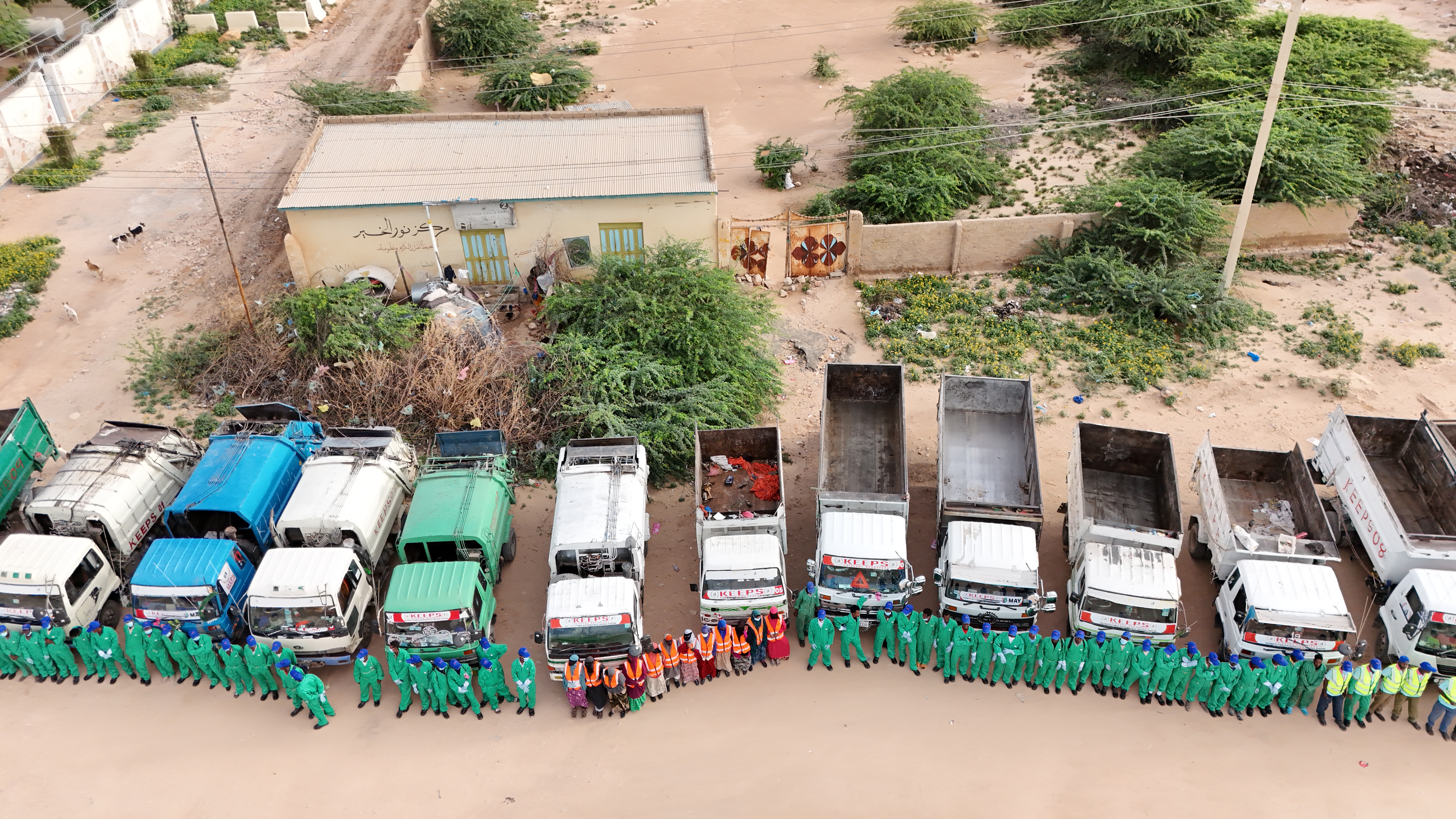 Overhead shot of KEEPS employees lined up nicely in front of the work trucks