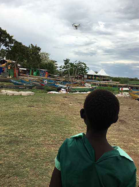 boy watching drone