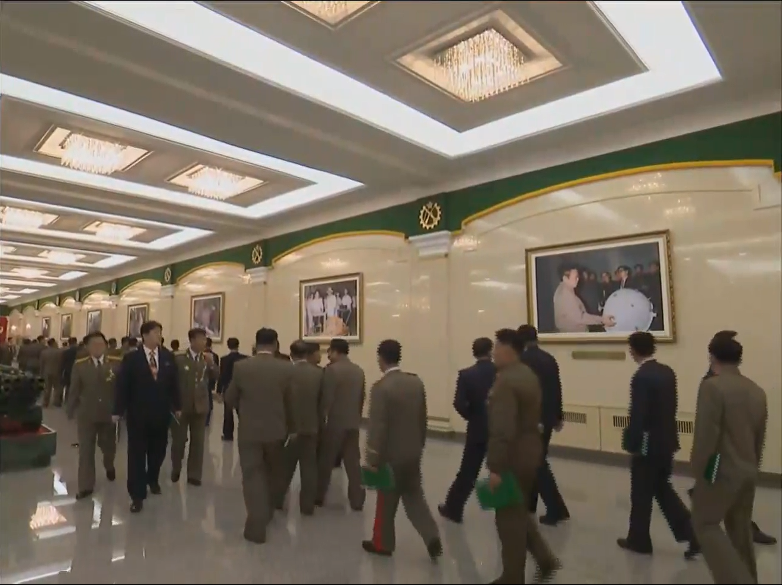 Figure 1. Kim Jong Il inspecting a spherical item, shown during a December 2017 meeting celebrating the State’s development of nuclear armed forces. Image: KCTV