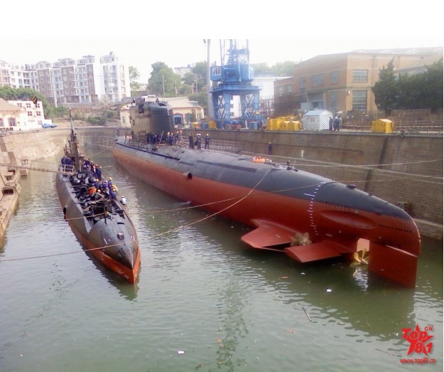 Type 033 submarine and a Golf class submarine in a dry dock in China
