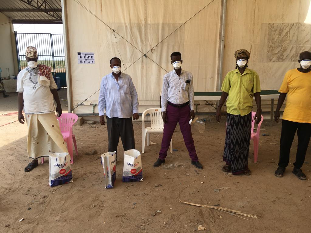 Community members in Zeila, Somaliland show how to properly wear masks and personal protection equipment. Co-management, COVID-19 information, Fisheries.