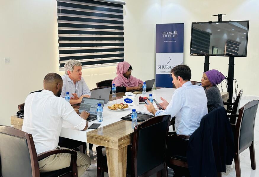 Shuraako, OEF and IFU Employees meeting around a table