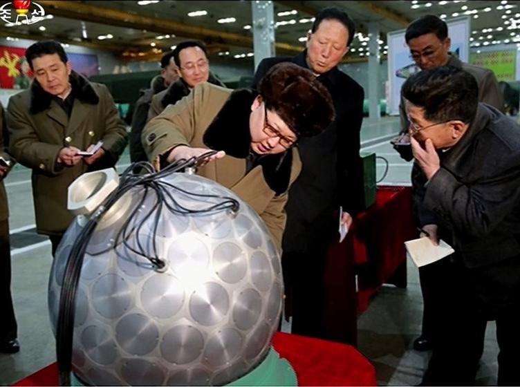 Image of Kim Jong Un next to bomb model