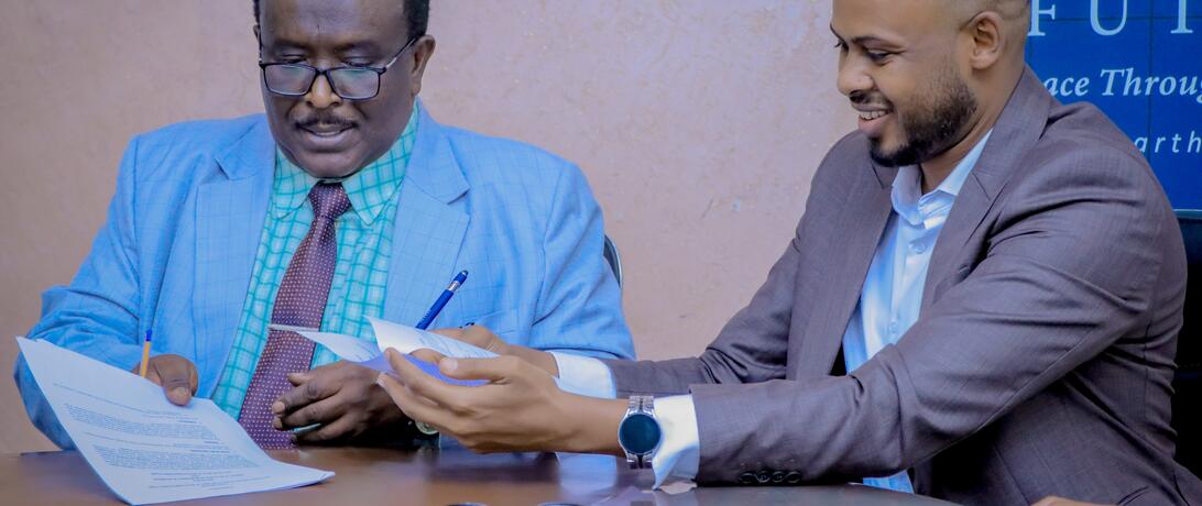 Minister of Investment and Industrial Development, HE. Abdirasak Ibrahim Mohamed, and Abdirahman Hashi, the Somaliland Director of Shuraako smiling after signing memorandum of understanding 