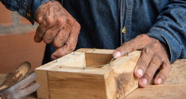 Hands building a beekeeping box, Saravena, Arauca.