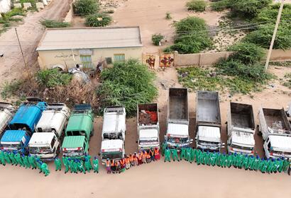 Overhead shot of KEEPS employees lined up nicely in front of the work trucks