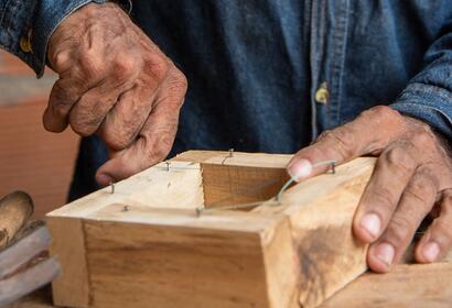 Hands building a beekeeping box, Saravena, Arauca.